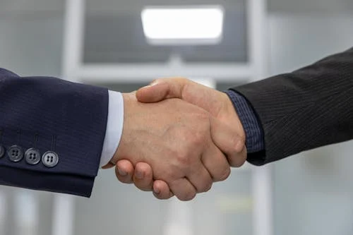 Technician servicing air conditioning equipment — partnership with Urban AC Solution